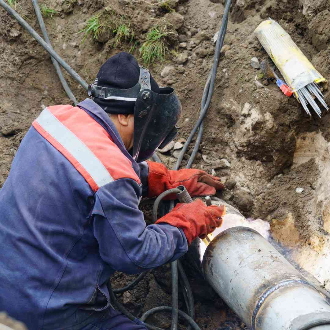 plumber fixing broken water main