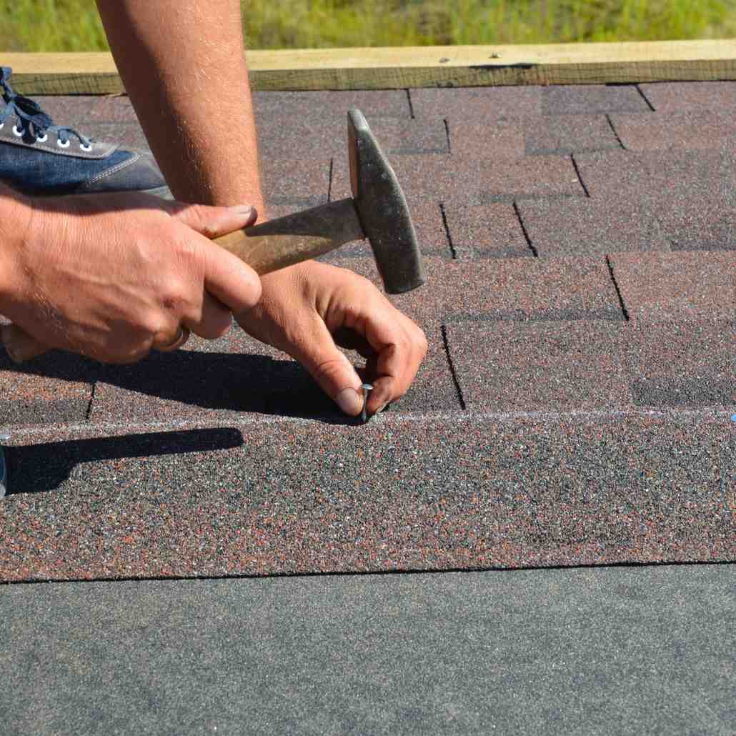 Roofer installing asphalt shingle
