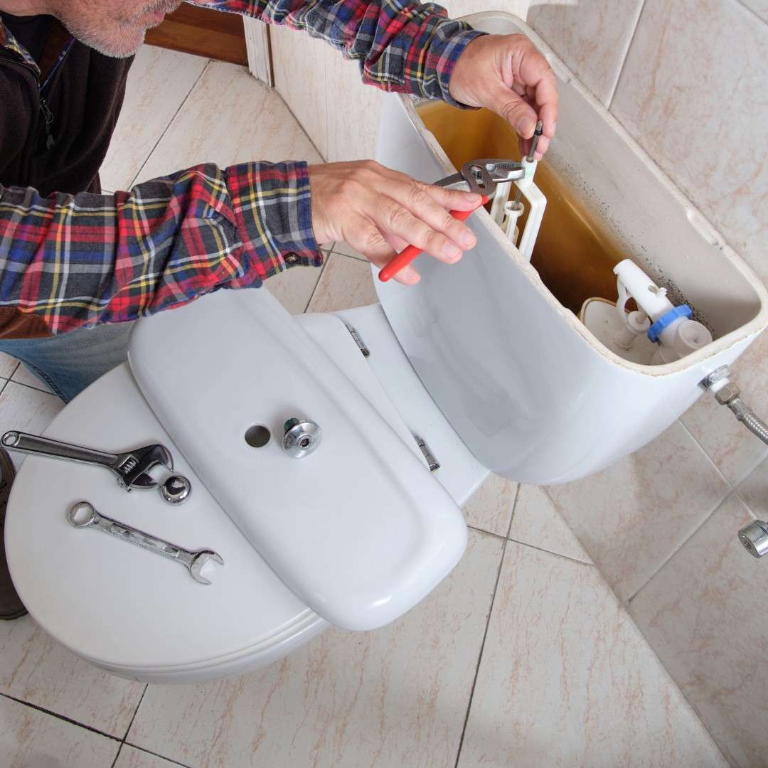 plumber installing a bathroom toilet